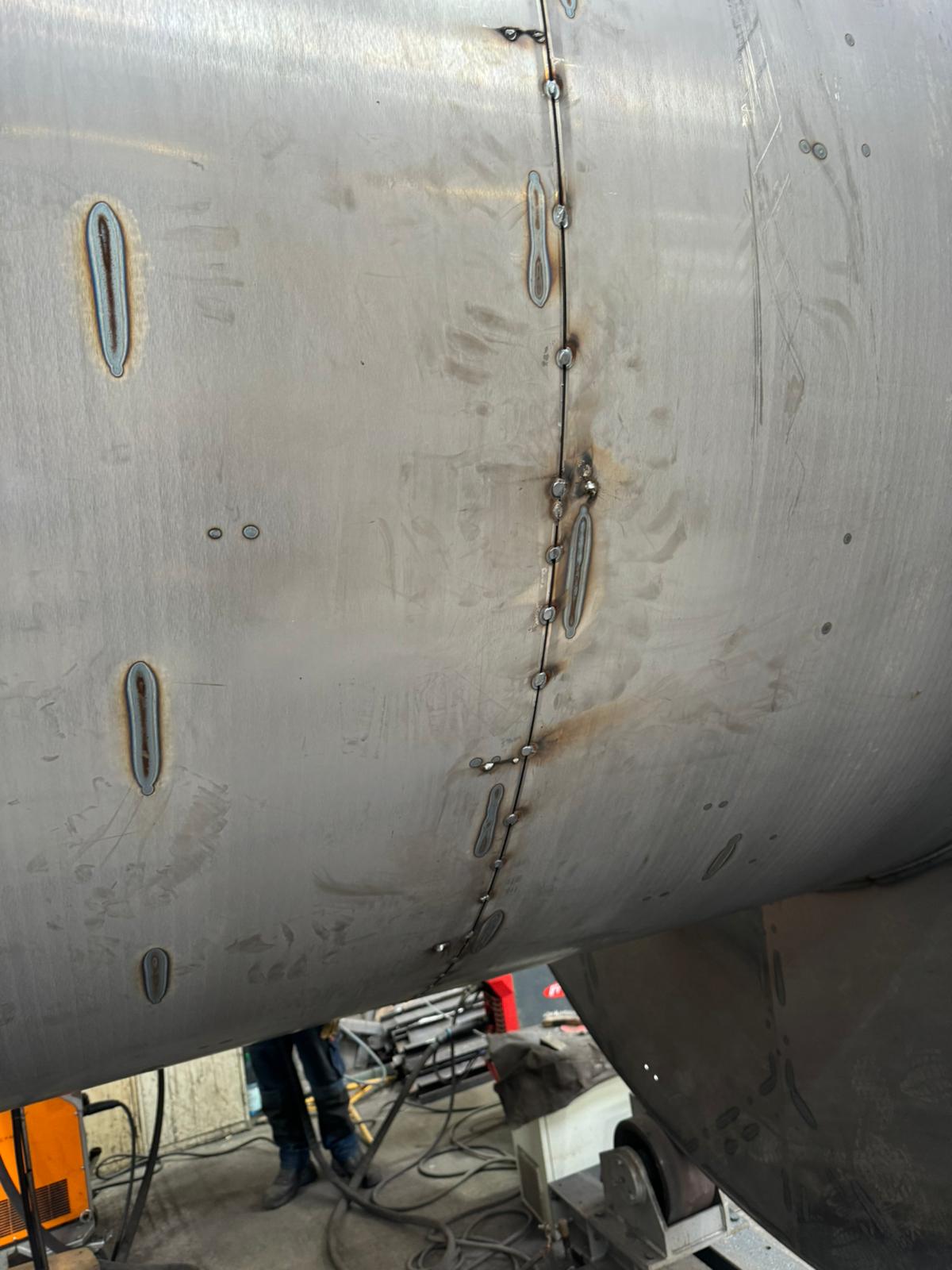 Industrial welding on large steel cylinder